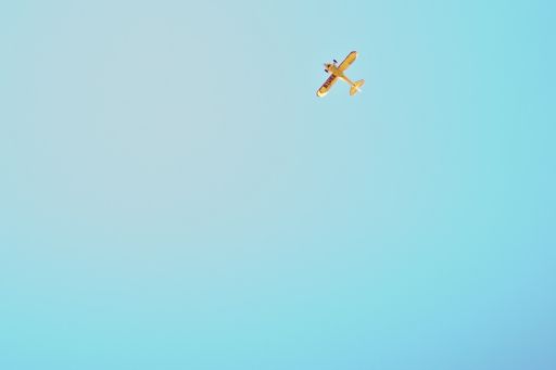 Aeroplane flying against blue sky