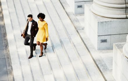 Man and woman walking down stairs together