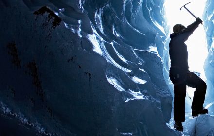 Man exploring glacial cave