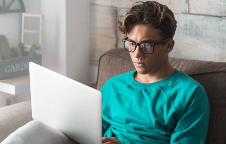 Man in glasses using his laptop