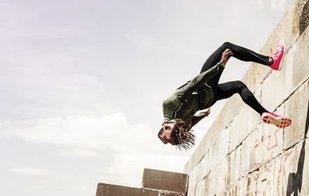 Man jumping backwards off a wall