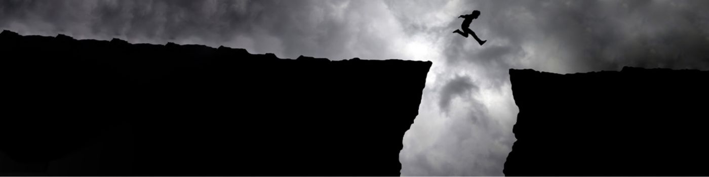 Man jumping from cliff - Dark clouds