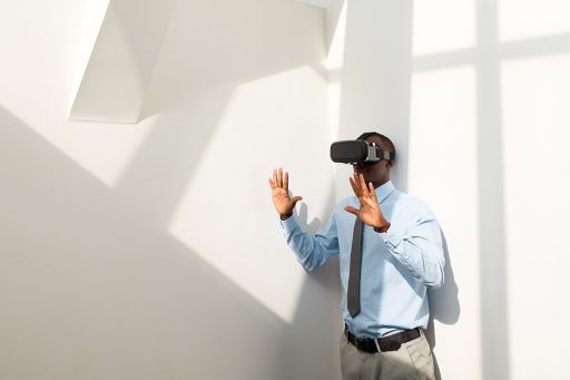man using virtual reality glasses in white room