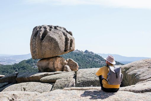Man with a backpack sitting on rocks