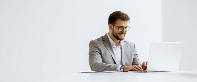 Man sitting in front of white laptop