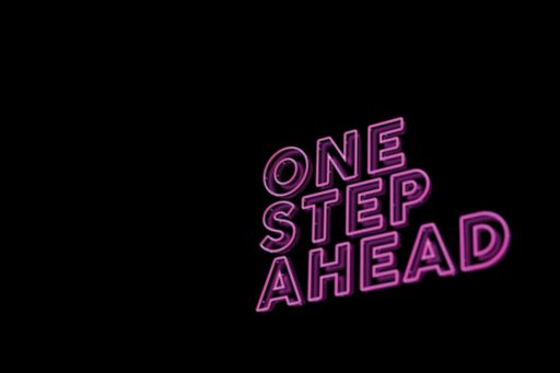 'One step ahead' written in pink neon writing on a black background