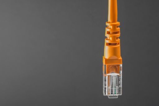 Orange network cable on dark background