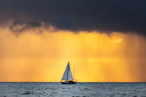outrigger sailboat on the horizon