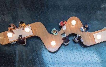 Overhead view of business meeting on a curvy table