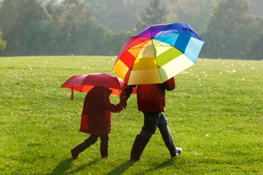 parent child holding colorful umbrellas