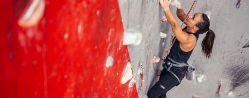 Woman climbing wall