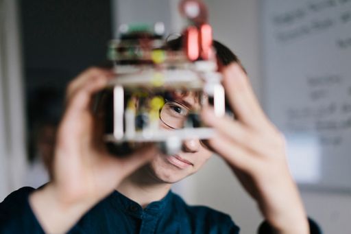 Teenager admiring homemade robot