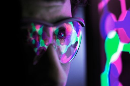 Person with goggles studying multi-coloured connected dots