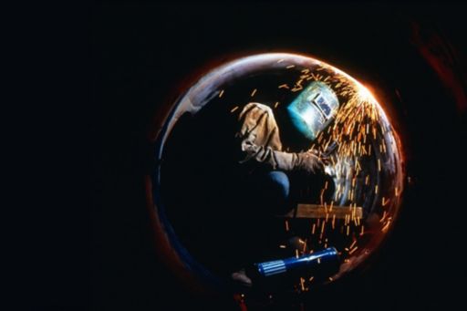 Person working in a bubble against black background