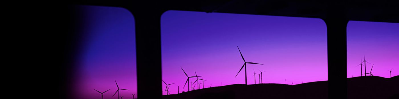 Renewable energy windmills in purple sunset
