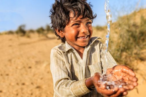 SDG boy smiling water