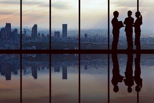Silhouette of three business people having discussion in office