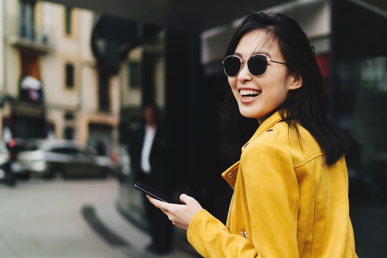 Smiling woman in yellow jacket