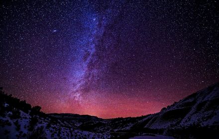 Starry night sky over mountains