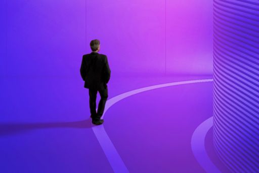 Man in business suit against a purple background