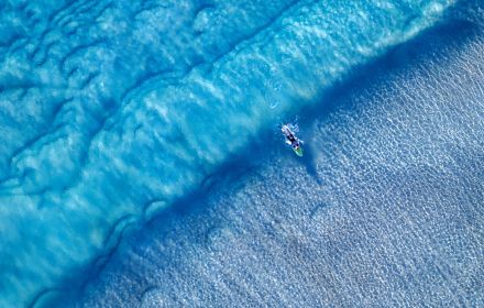 Aerial view of surfer riding waves