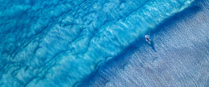 Aerial view of surfer riding waves