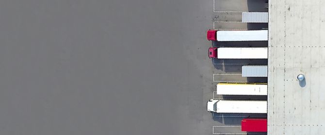 Top view of heavy vehicles parked in a row down the road