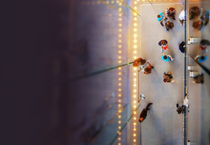 Top view of people in a hallway with lights