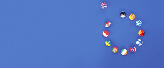 Spherical EU country flags on blue background