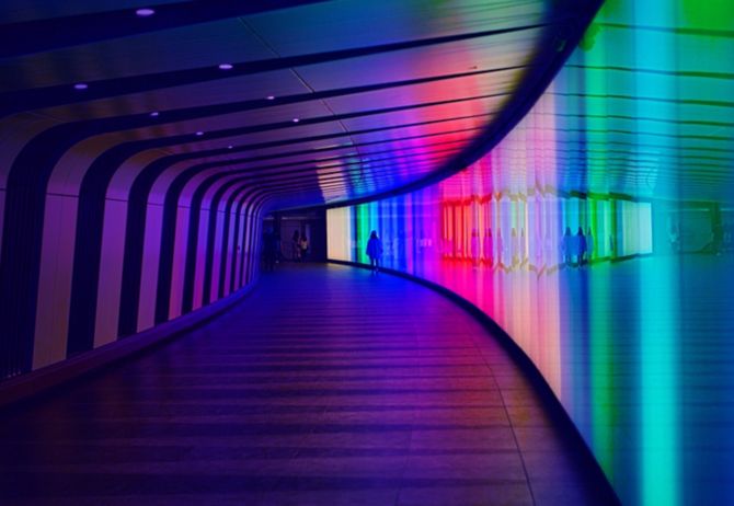 Tunnel of lights with pedestrians walking through