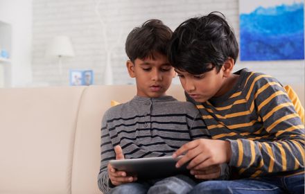 Two boys watching something on tablet device