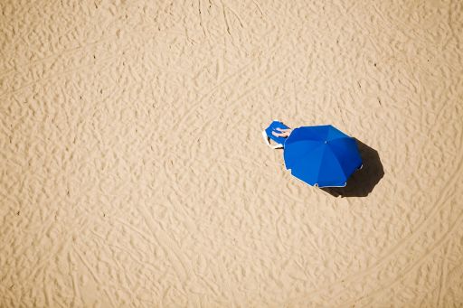 Blue umbrella on sandy beach