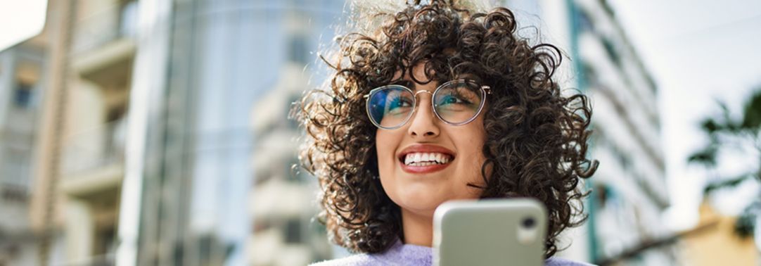 Woman with curly hair using phone