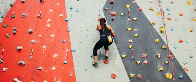 women climbing indoor wall
