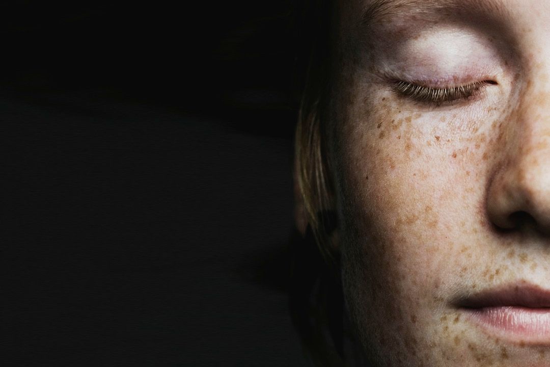 women face with closed eye
