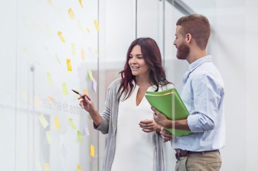 Business people planning using sticky notes
